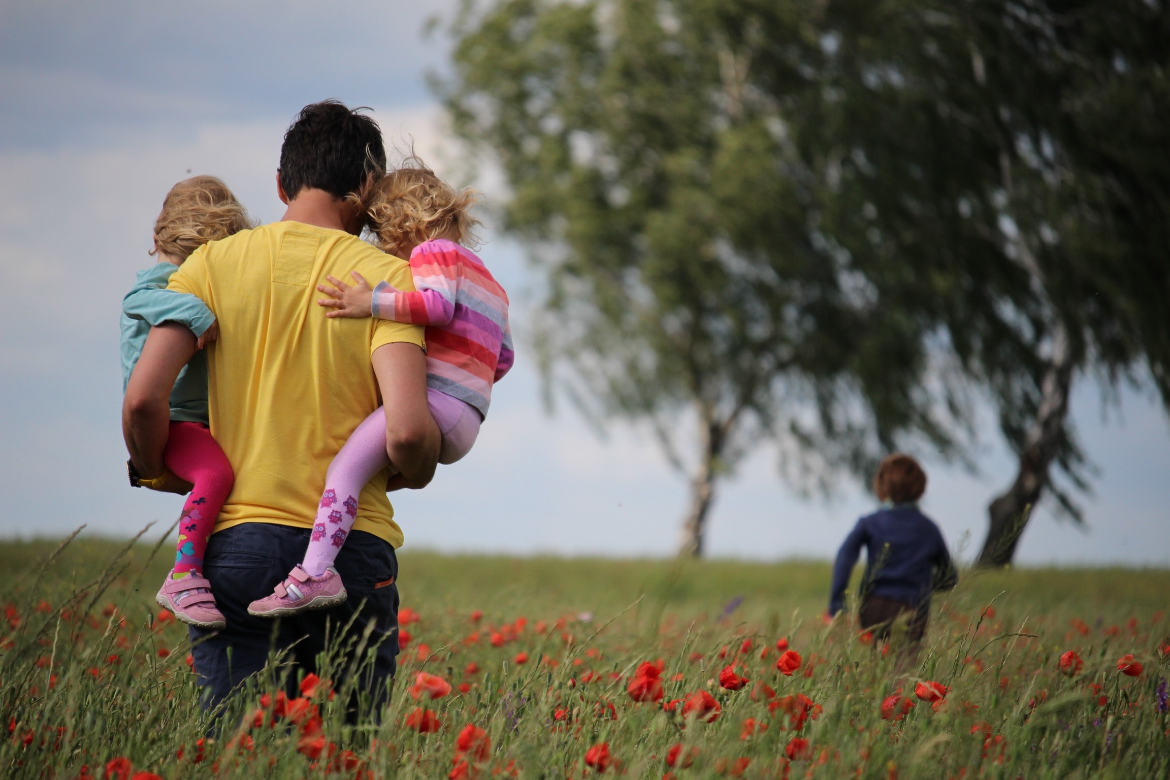 Man in Field with Family